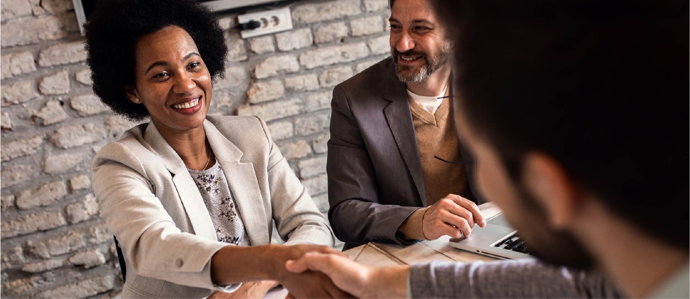 image of a woman shaking someone's hand